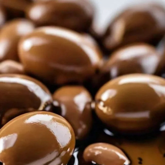 TruffLuv oil capsules close-up showing glossy argan oil beads for hair nourishment